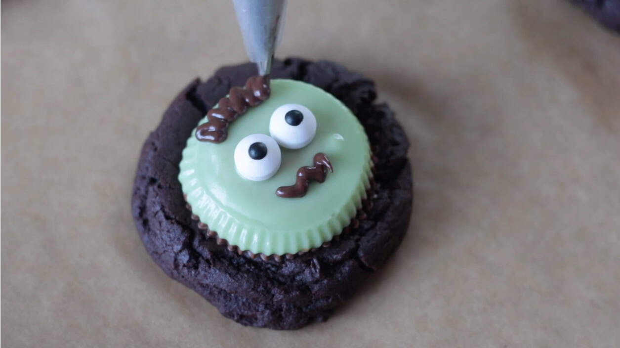 Melted chocolate added to top of cookie for Frankenstein eyebrows.