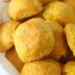 Bread basket full of pumpkin dinner rolls.