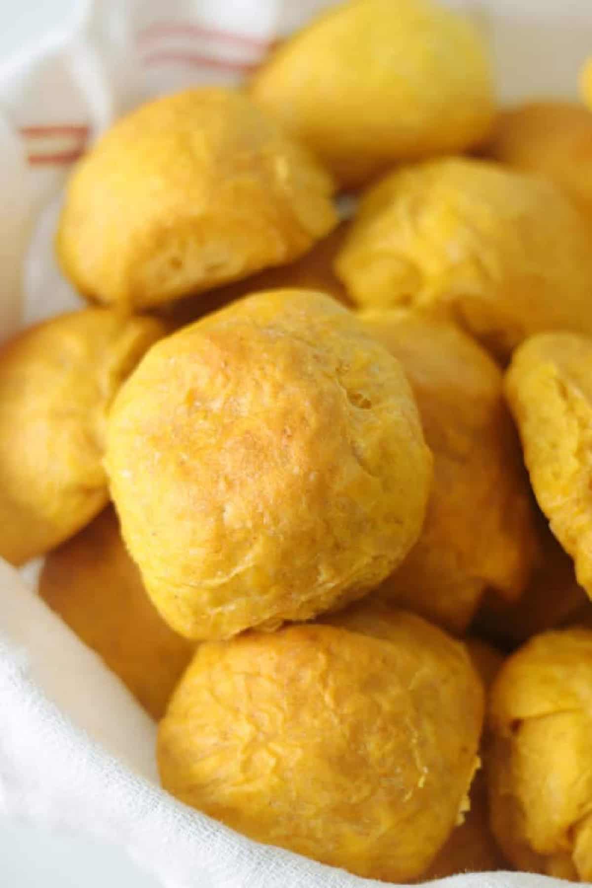 Bread basket full of pumpkin dinner rolls.