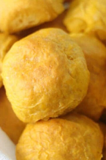 Bread basket full of pumpkin dinner rolls