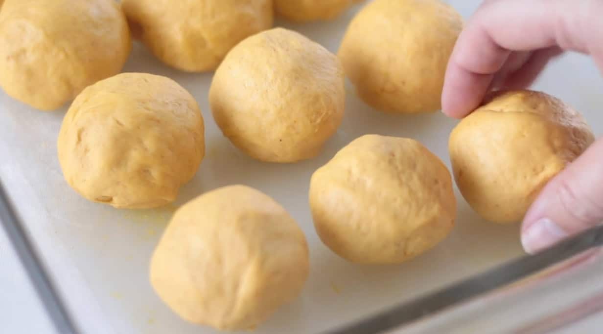 Baking dish with balls of bread dough.