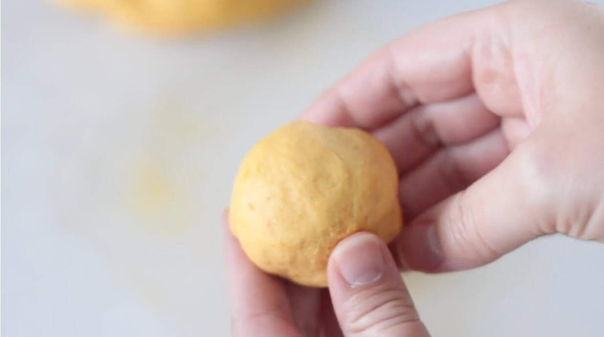 Hand rolling dough into balls.