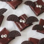 Bat brownies on parchment paper.