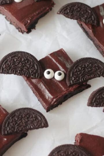 Bat brownies on parchment paper.