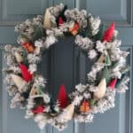 Wreath with bottlebrush trees attached in a variety of colors.