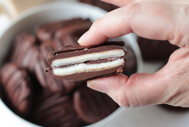 hand holding homemade peppermint patty cut in half