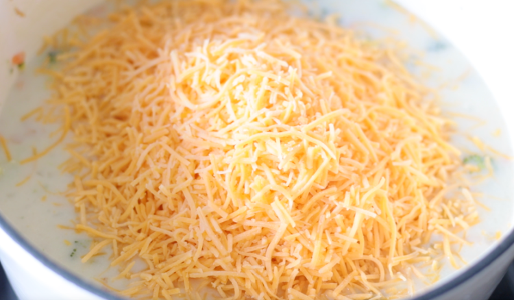 shredded cheese poured over soup