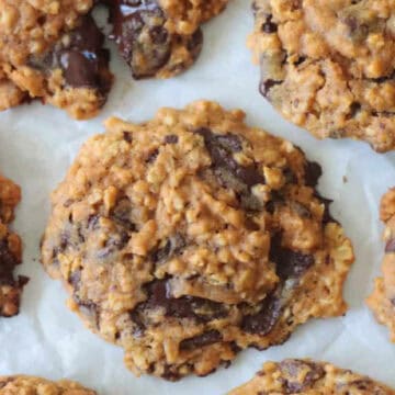 Pumpkin oatmeal chocolate chip cookies on parchment paper.