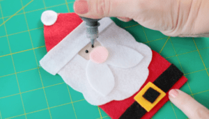 fabric paint eyes being painted on santa