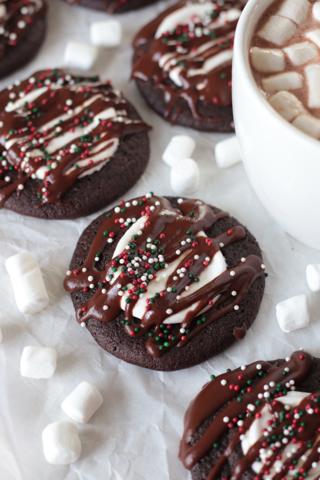 hot cocoa cookies next to a mug of hot cocoa