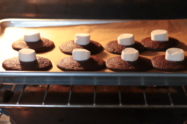 cookies in oven with marshmallows on top