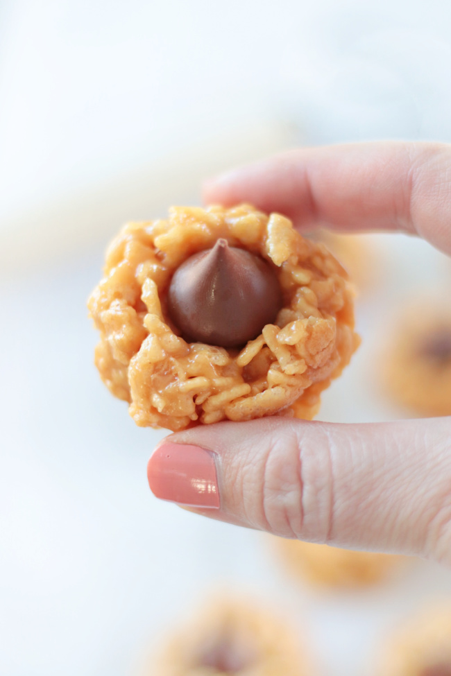 hand holding no bake peanut butter blossoms cookie