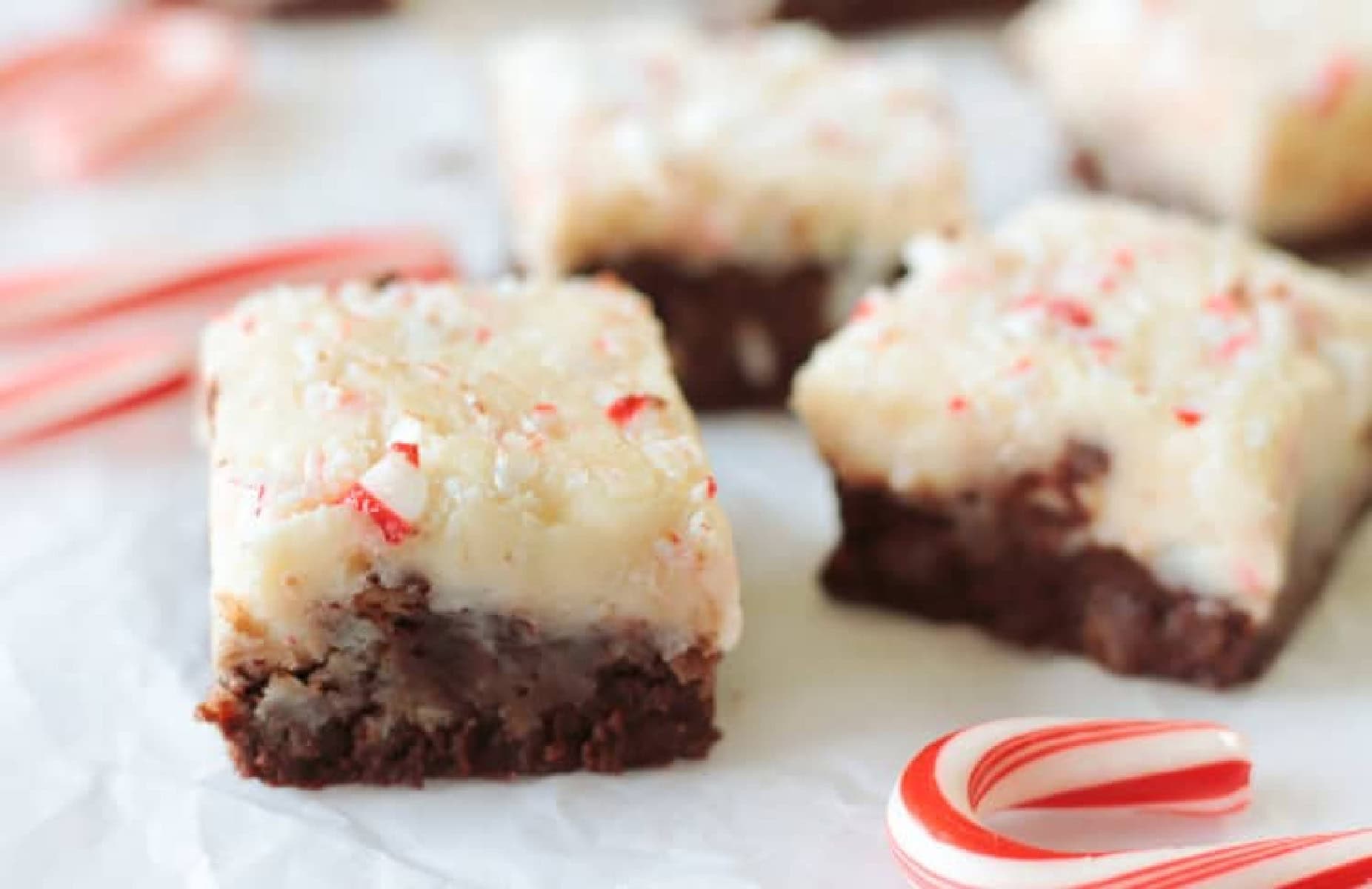 Squares of peppermint fudge on parchment paper.