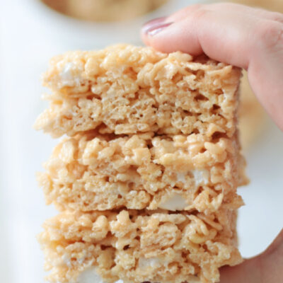 hand holding stack of salted caramel Rice Krispies treats