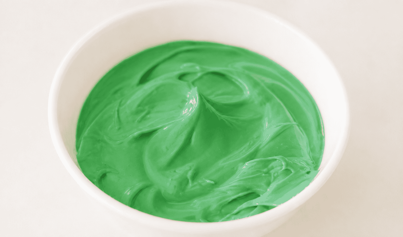 Bowl of green melting chocolate. 
