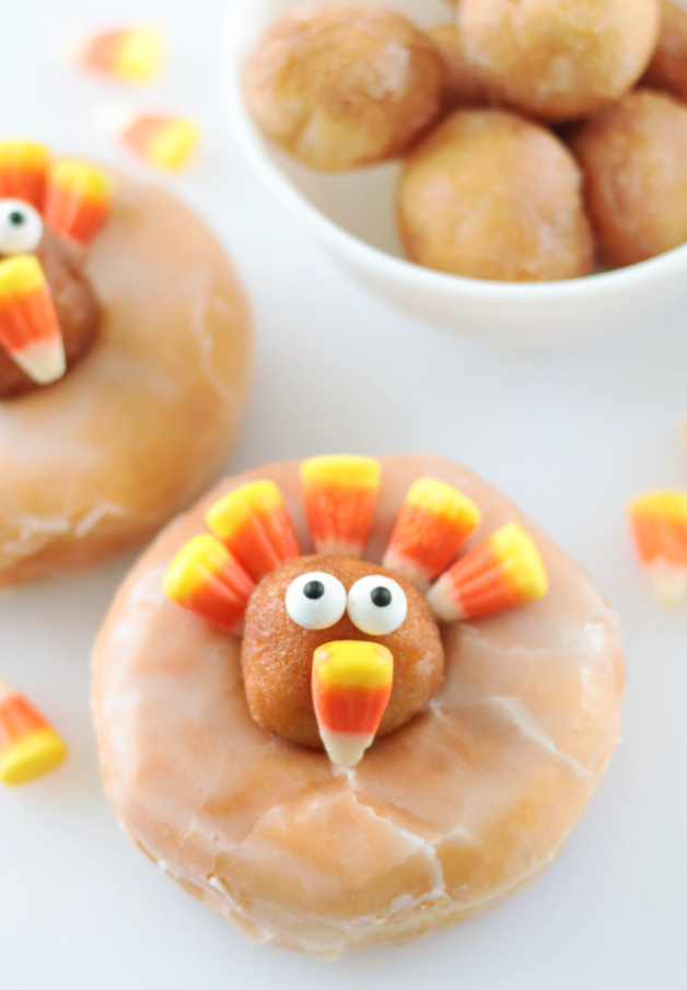 two turkey donuts decorated with candy corn
