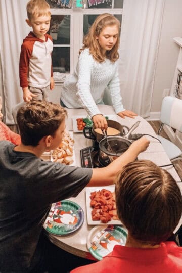 kids dipping food into fondue pots