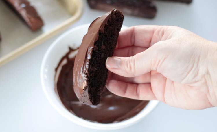 hand holding chocolate dipped biscotti