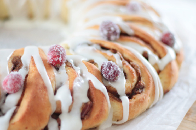 cinnamon roll wreath with cranberries and glaze