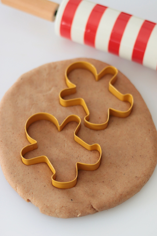 two gingerbread man cookie cutters on play dough