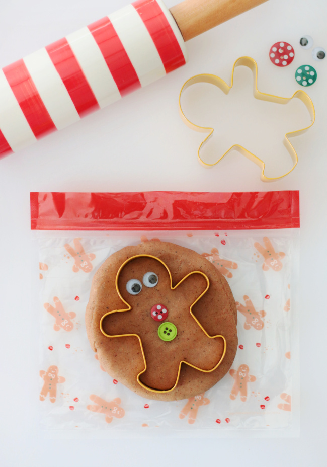 gingerbread play dough and cookie cutter on plastic baggie