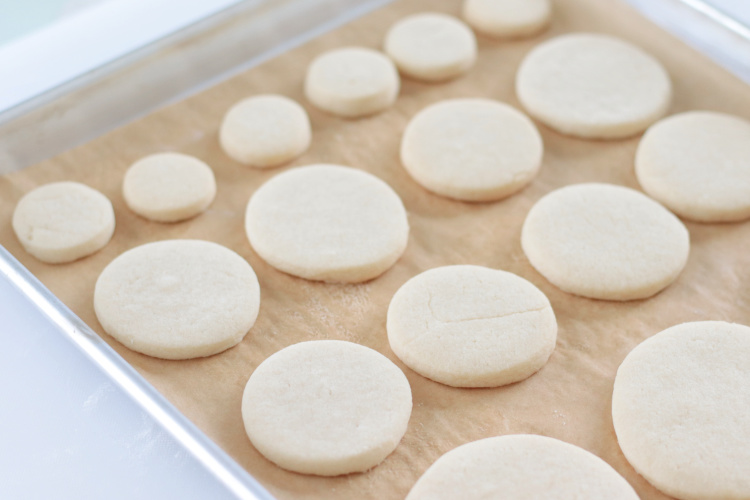tray of baked round sugar cookies in various sizes