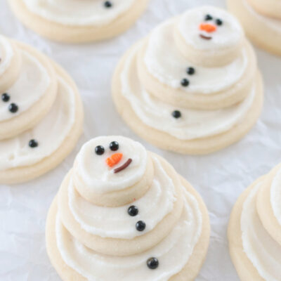 snowman sugar cookies on parchment paper