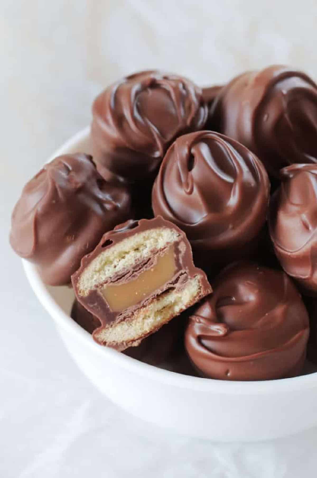 Bowl of Twix bites, one cut in half.