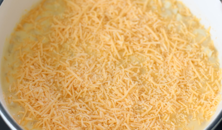 shredded cheese sprinkled over macaroni and cheese