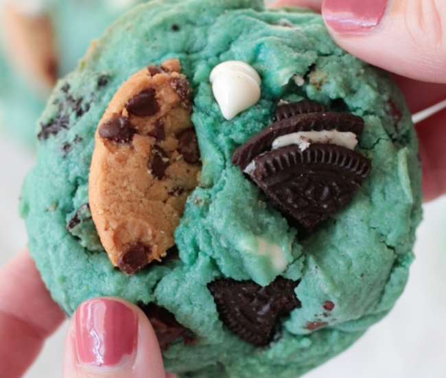 hand holding blue chocolate chip cookie