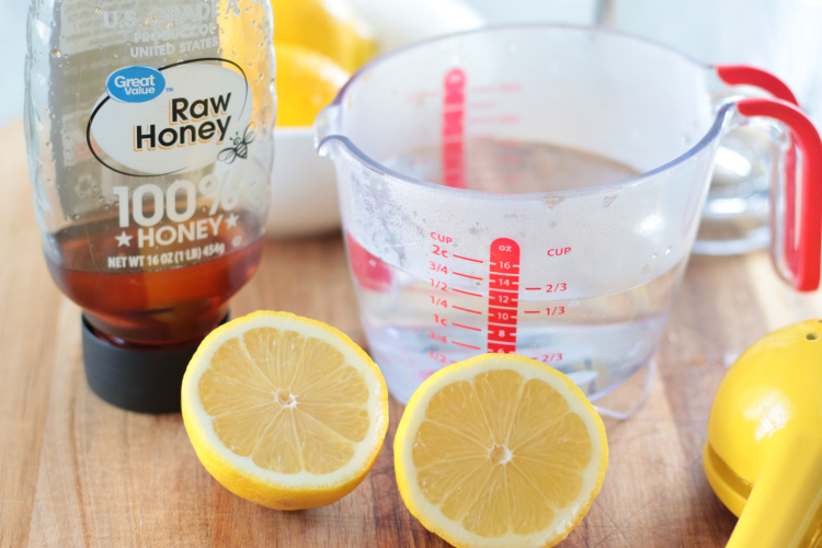lemon halves, honey and a cup of hot water