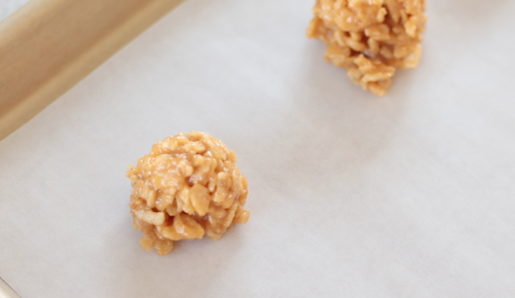 scoops of Rice Krispies mix on parchment paper