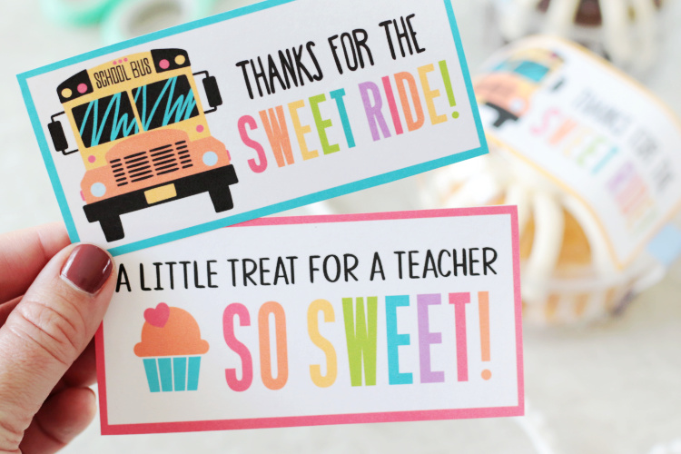 hand holding two colored teacher appreciation gift tags
