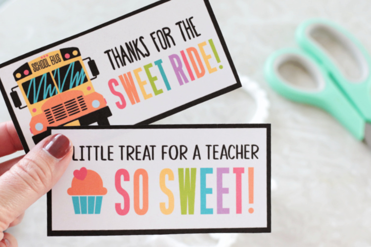 hand holding two printable teacher appreciation gift tags