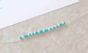blue and white beads on stretchy string