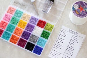 container of seed beads and morse code chart