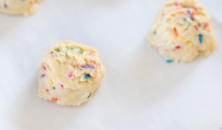 funfetti cookie dough balls on baking sheet