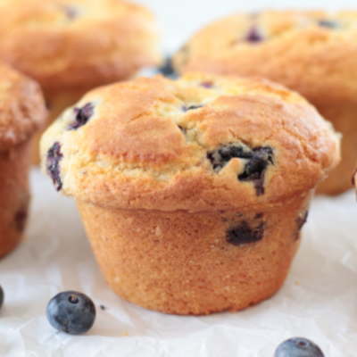 jumbo bakery-style blueberry muffins on parchment paper
