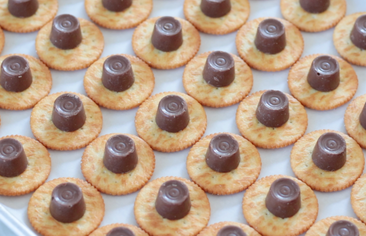 tray or ritz crackers with rolo candies on top.