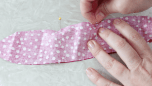 hands adding pins into fabric