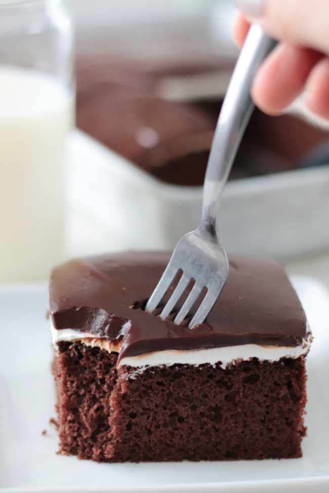 fork poked into slice of chocolate cake