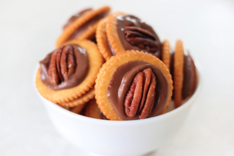 bowl of ritz rolo cookies with pecans on top