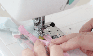 pink zipper sewn in sewing machine
