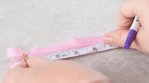 measuring tape against zipper