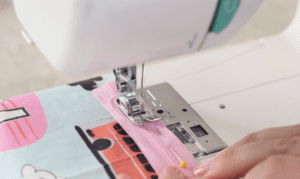 pink zipper pinned and sewn in sewing machine