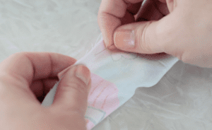hands pinning fabric