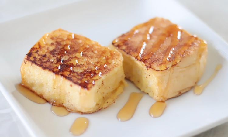 two pieces of French toast with maple syrup
