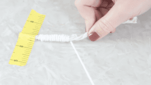 hand wrapping yarn around cotton cording