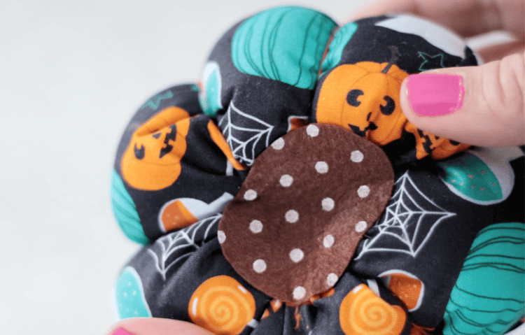 small piece of felt glued to the bottom of the fabric pumpkin.