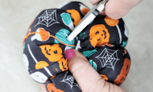 pliers pulling needle through fabric pumpkin
